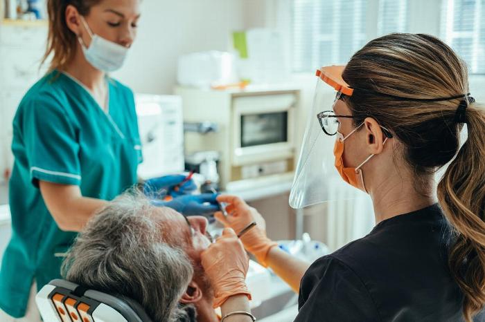 Dentist and Dental nurse with elderly patient