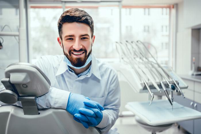 Male dentist smiling at camera